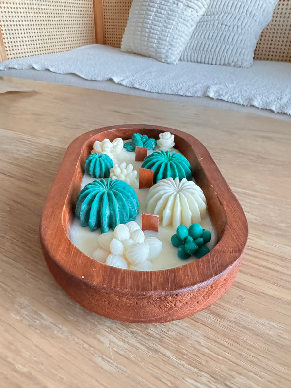 Cactus dough bowl candle on a wooden coffee table in a living room