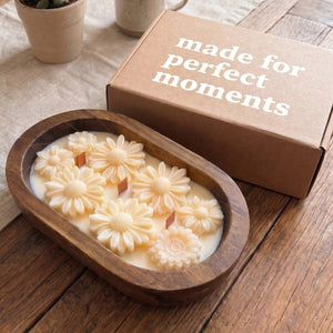 Lit Daisy dough bowl candle with three wooden wicks